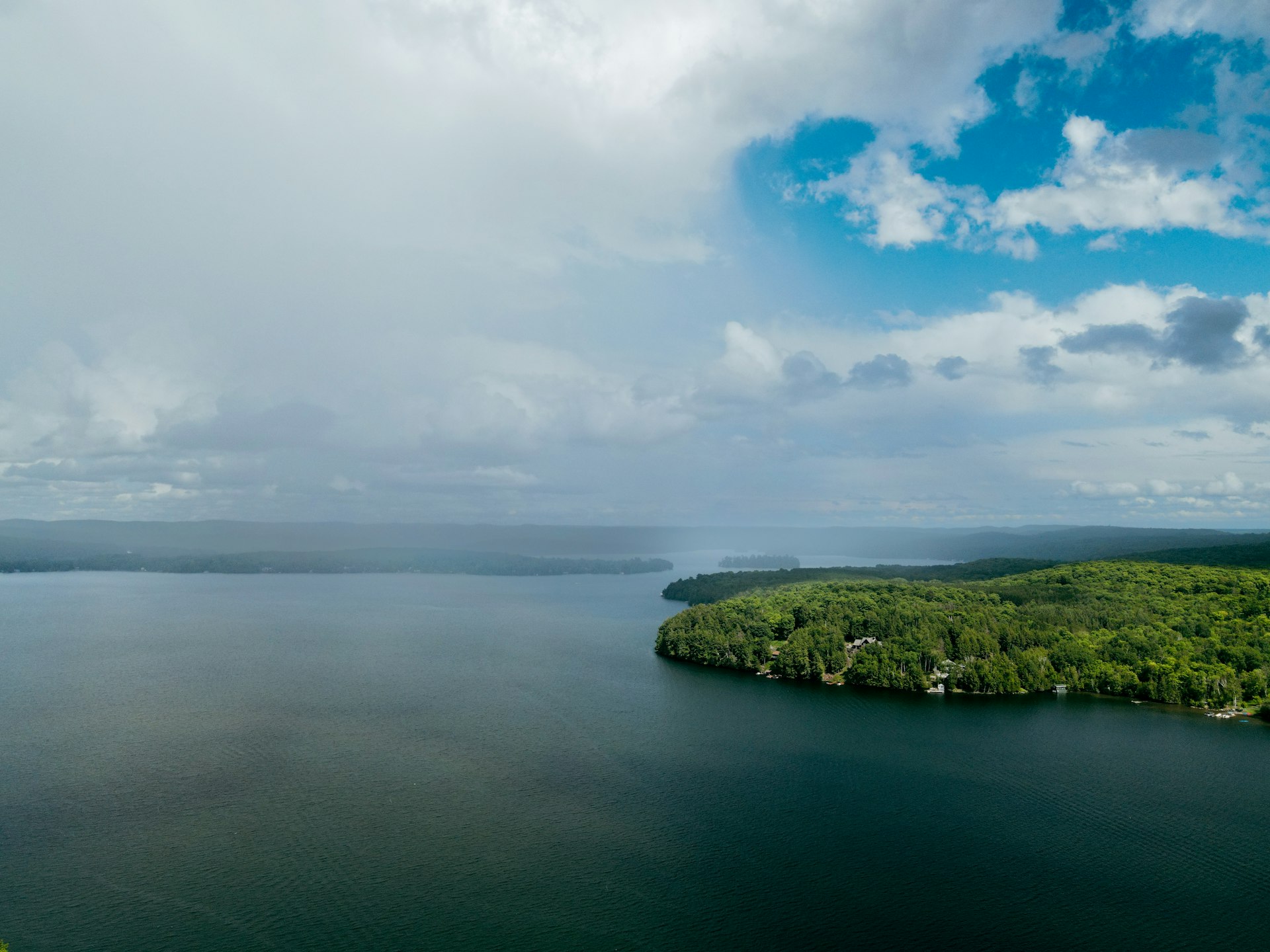 a large body of water surrounded by lush green trees